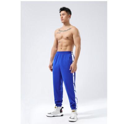 China Anti-Wrinkle Fashion Button Tear Up Fitness SportsLong Professional Cargo Pants Running Away Casual Pants For Men for sale