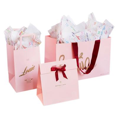 China Recycled materials wholesale custom printed pink christmas paper gift bags from china paper bag manufacturers for sale