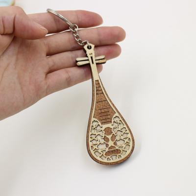 China Customized Hotel and Resort Musical Instruments Key Chain Wooden Modern Classical Musical Instrument Keychain for sale