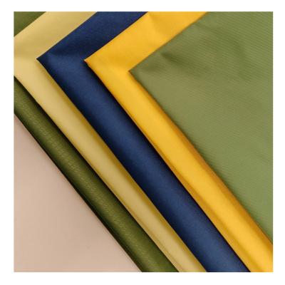 China Olive green double taffeta 310t side waterproof nylon waterproof label softsgell fabric with lining for jackets for sale