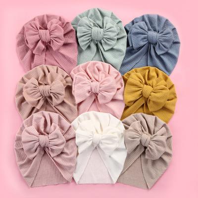 China Striped Fashion Baby 2023 Soft Turban Hats Ribbed Cotton With Spandex Solid Color Toddler Baby Hat Children Bow Soft Hat For 0-4 Years for sale