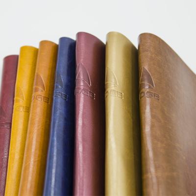 China Abrasion-resistant hot stamping custom printed color change pu faux leather fabric vegan leather for notebook for sale