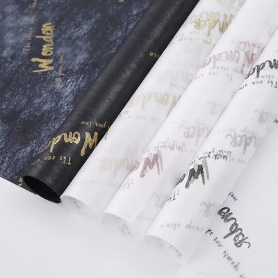 China Waterproof Cheap Non Woven Fabric Words Printed Gift Flowers Wrapping Color Tissue Paper For Florist Valentine Day for sale