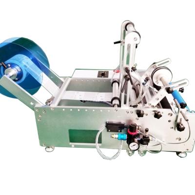 China Professional Manual Food Table Top Round Bottle Labeling Machine with Code Date Printer for sale