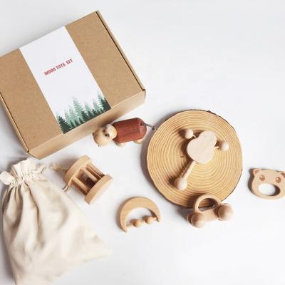 China Eco-Friendly Natural Eco-Friendly Infant Molar Wooden Bell Ring Ring Bag Gift Bag Perception Handle Baby Gift Box Amazon Best Seller Baby Teether Set For Babies for sale