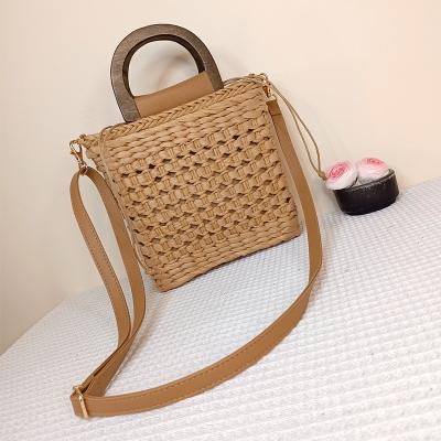 China Straw Beach Bags 2023 Solid Color Handwoven Drawstring No Shoulder Bags Factory Fashion Wooden Handle Messenger Bags for sale