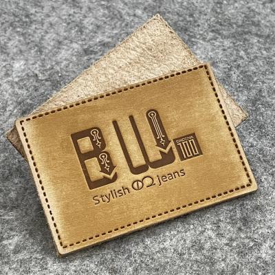 China Customized Washable Genuine Leather Old Vintage Hot Stamping Leather Label Embossed Letters Logo Garment Jeans Leather Labels for sale