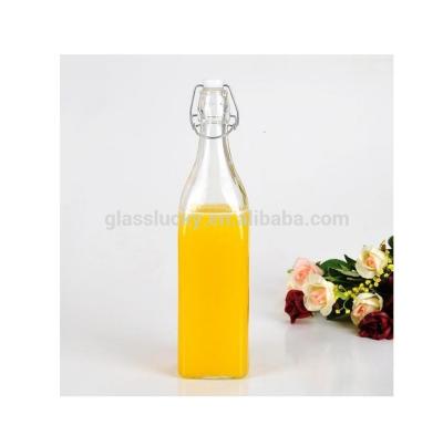 China 1L Beverage Glass Water Bottle Clear Glass Bottle With Swing Top Cap for sale