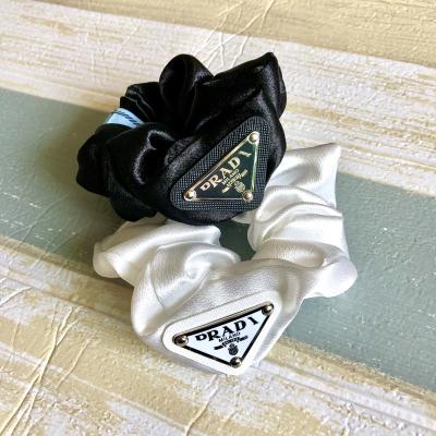 China Luxury Women Girls Brand Designers Designer Hair Accessories Famous Elastic Scrunchy Silk Satin Wrist Band Scrunchy Make Up Hair Bands for sale