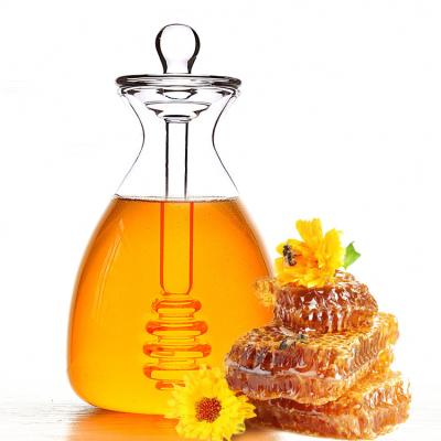 China Heatable handmade clear borosilicate glass honey jar jar with plunger and dustproof lid for sale