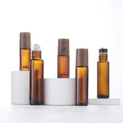 China Personal Care 5ml 10ml Matte Amber Dark Wood Bamboo Essential Oil Roll Ball Stainless Steel Refillable Glass Bottle Lids Roll On Bottle for sale