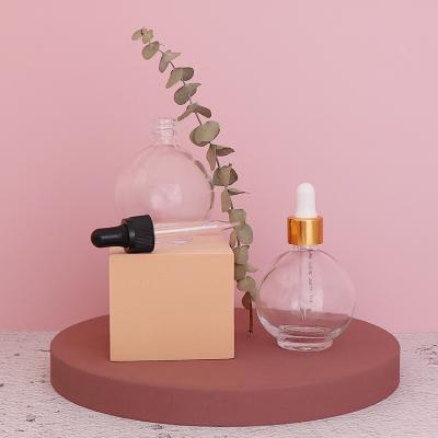 China Personal Care 70ml Ball Shape Clear Essential Oil Glass Bottle With Dropper Lid for sale