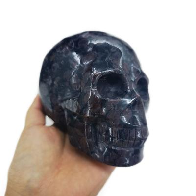 China Natural Europe Realistic Skull Crystal Gem Model Handmade Garnet Matrix Astrophyllite Skulls For Wholesale for sale