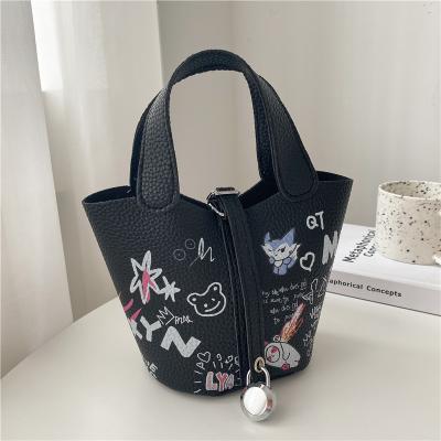 China Fashion Graffiti Printed Bucket Bag PU One Shoulder Cross - Body Fashion PU Women Handbag for sale