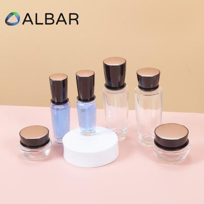 China 30ml 50ml 100ml Eco-friendly Recyclable Cosmetics Thick Bottom Transparent Glass Shoulder Flat Bottles For Face And Body Care for sale