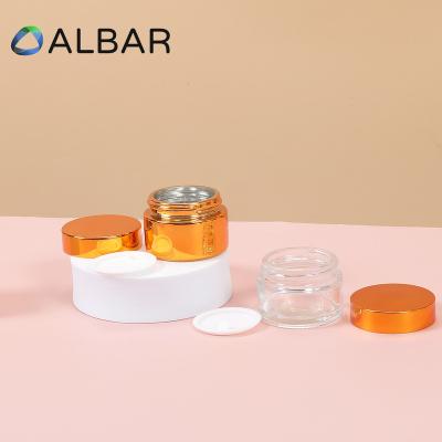 China 30g 50g 80g Eco - Friendly Recyclable Cosmetics Glossy Surface Face Cream Glass Jars In Painted Plating Amber And Silver Gold for sale