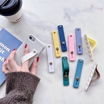 China Adjustable Universal Wristband Strap Phone Holder Candy Color Silicone Mobile Phone Grip Stretch Push-pull Stand for sale