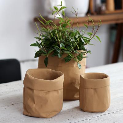 China Creative Modern Minimalist Ins Style Home Greenery Potted Plants Cement Faux Cowhide Bags Flower Pots for sale