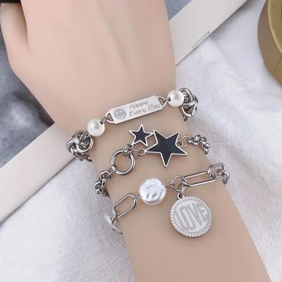 China Multi Style Titanium Steel Key Lock Heart Hiphop Double Layer Butterfly Blade Cross Charm Bracelets for sale