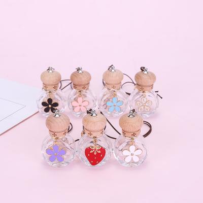 China Car Cosmetic Air Fresher Refill Empty Hanging Perfume Bottle With Wooden Cap And Finial Pendant for sale