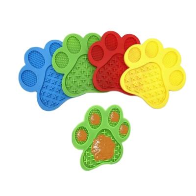 China Viable Wholesale Paw Shape Nonslip Dog Slow Feeder Silicone Smart Sucker Anti-skid Wall Suction Pet Lick Pad for sale