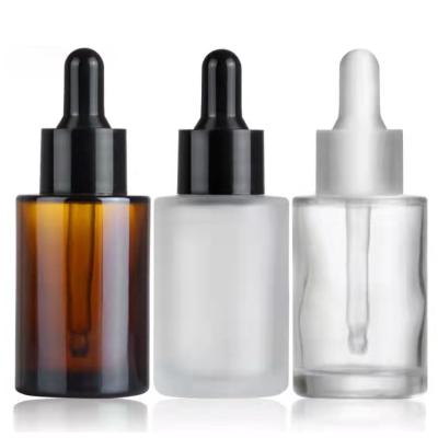 China Cosmetic 1oz/30ml Serum Packaging Round Clear Glass Bottle With Glass Frosted Amber Flat Shoulders Dropper For Essential Oils for sale