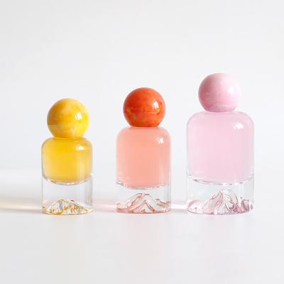 China Cosmetic BAIDE Volcanic Floor 30ml 50ml 100ml Empty Glass Perfume Spray  Bottles with Resin Spherical Cap for sale