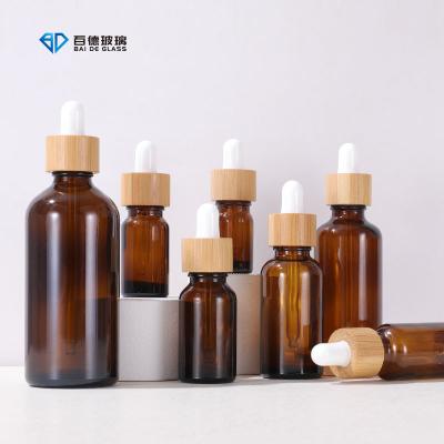 China Cosmetic 5ml 10ml 15ml 20ml 30ml 50ml 100ml frosted green blue amber clear essential oil glass dropper bottle with bamboo lid for sale