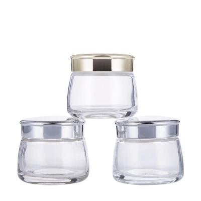 China Manufacturers 100g Cosmetic Stock Glass Face Cream Jar Transparent Frosted Container For Cosmetics With Wedge Ang Cap for sale