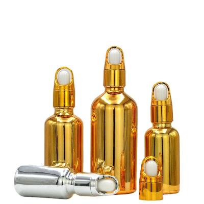 China Exquisite Round 30ml Essential Oil Cosmetic Plating Dropper High End Glass Bottle With Gold Glass Essential Oil High Quality Bottle for sale