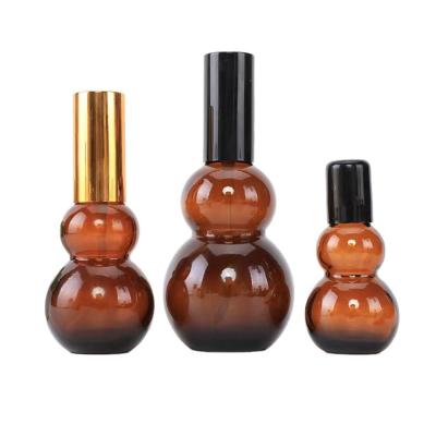 China Distinct Amber Light Proof Glass Dropper Essential Oil Pumpkin Bottle Brown Double Pumpkin Shape Glass Cosmetic Hot Selling Dropper Bottle for sale