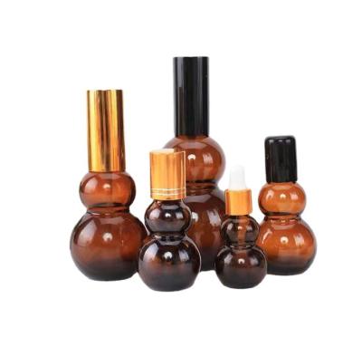 China 10ml 20ml 30ml 50ml 100ml Essential Oil Glass Bottle Cosmetic Creative Amber Gourd Shape for sale