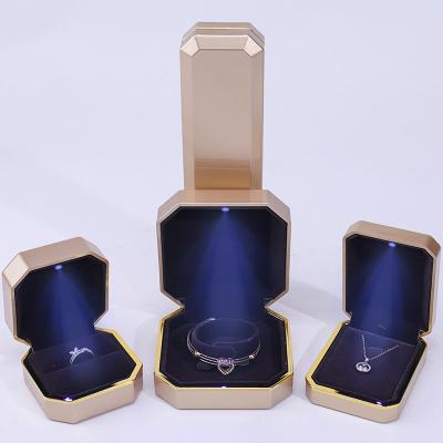 China Octagonal Convex Plastic Velvet Jewelry Box LED Light Display Case Custom Size for sale