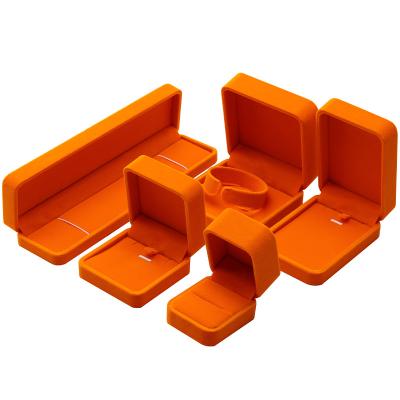 China Logotipo personalizado Caja de joyería de terciopelo naranja para el embalaje de anillos en plástico y terciopelo en venta