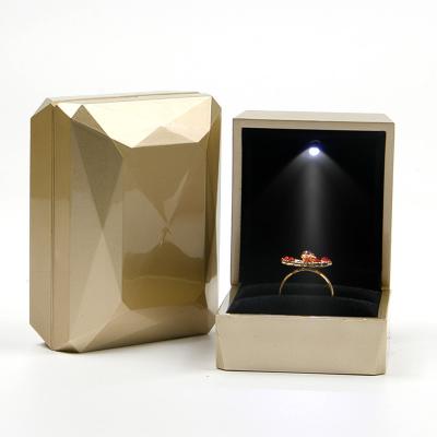 China Custom Logo PU Plastic Gold Jewelry Packaging Box with LED Light Jewelry Package for sale