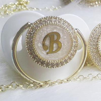 China 100% Dollbling Eco-Friendly Idyllic Incredible Color Letter B Transparent White Brass Pacifiers for sale