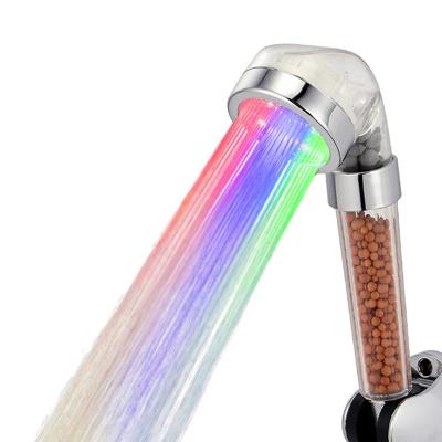 China Needleless Pressure Boosting Mineral Stone Filter 3 Colors Flash Led Shower Head for sale