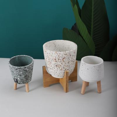 China Modern promotional matte terrazzo indoor flowerpot green plant outdoor garden pots/home decor with wooden stand for sale