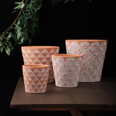 China Modern graceful pattern embossed matte modern design home decoration clay terracotta garden flower pot outdoor planter for plants for sale