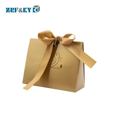 China Gift handmade gold paper bag with ribbons for present packaging, custom paper bag with your own logo for sale