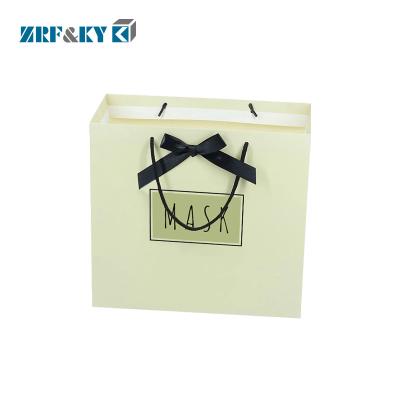 China Handmade Customized Packaging Paper Clothing Bag , Bespoke Euro Totes Paper Shopping Bag With Bowknot for sale