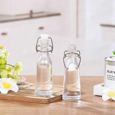 China Sustainable 50ml/Eco-friendly/Stocked 150ml Small Glass Beverage Bottle Drinkable Clear Bottle Glass For Juice Milk Water Dispenser With Swing Top for sale