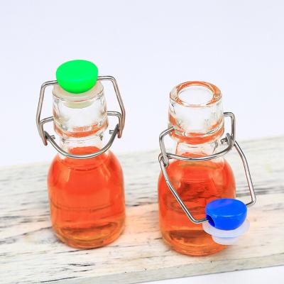 China Sustainable / Eco-friendly / Stocked 60ml Mini Glass Bottle Transparent For Drinking Swing Top Drink Bottles Glass Milk Glass Liquid Water Bottle for sale