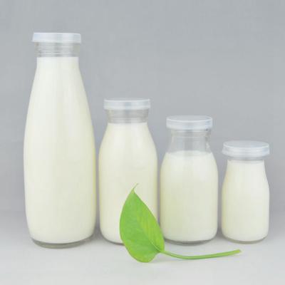 China Sustainable/Eco-friendly/Stocked Custom Mineral Water 100ml 200ml 250ml 500ml Juice Milk Glass Bottles Logo Glass Milk Bottle Beverage With Plastic Lids for sale