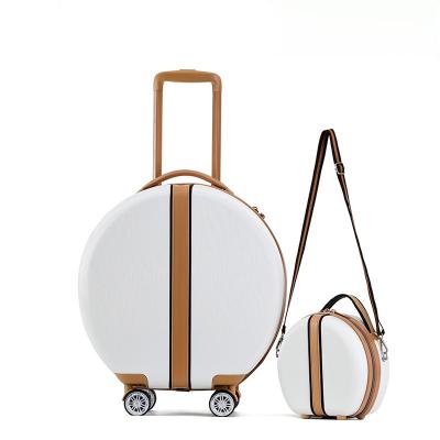 China Round Shape Luggage With White Strap Hard Shell Waterproof Suitcase Travel Trolley Luggage With Brown Strap for sale