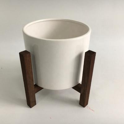 China Modern paulownia light wood designer material dark brown color planter with wooden stand for sale for sale