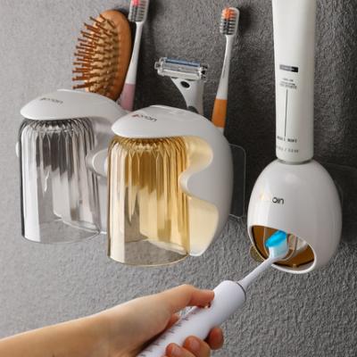 China Viable Magnetic Bathroom Accessories Holder Toothpaste Dispenser Automatic Toothbrish Holder For Home Bathroom Places Storage for sale