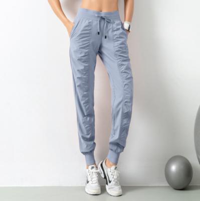 China Spring/Summer 2022 New Women Workout Sustainable Breathable Pants Slimming Loose Running Workout Pants With Nine Pockets Casual Feet for sale