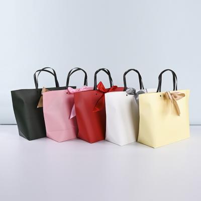 China Lipack Recyclable Women's Bowknot Jewelry Paper Bag Fancy Shopping Bag For Clothing Packaging for sale