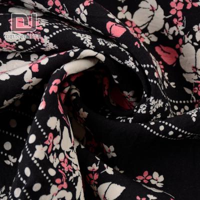 China New arrival black antistatic fancy woven printed 100% rayon challis fabric for dress for sale